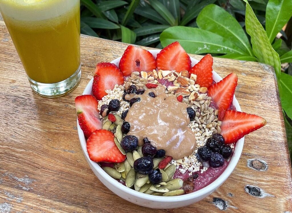 Artsy smoothie bowl with a pineapple juice at Raw Lov, Tulum.