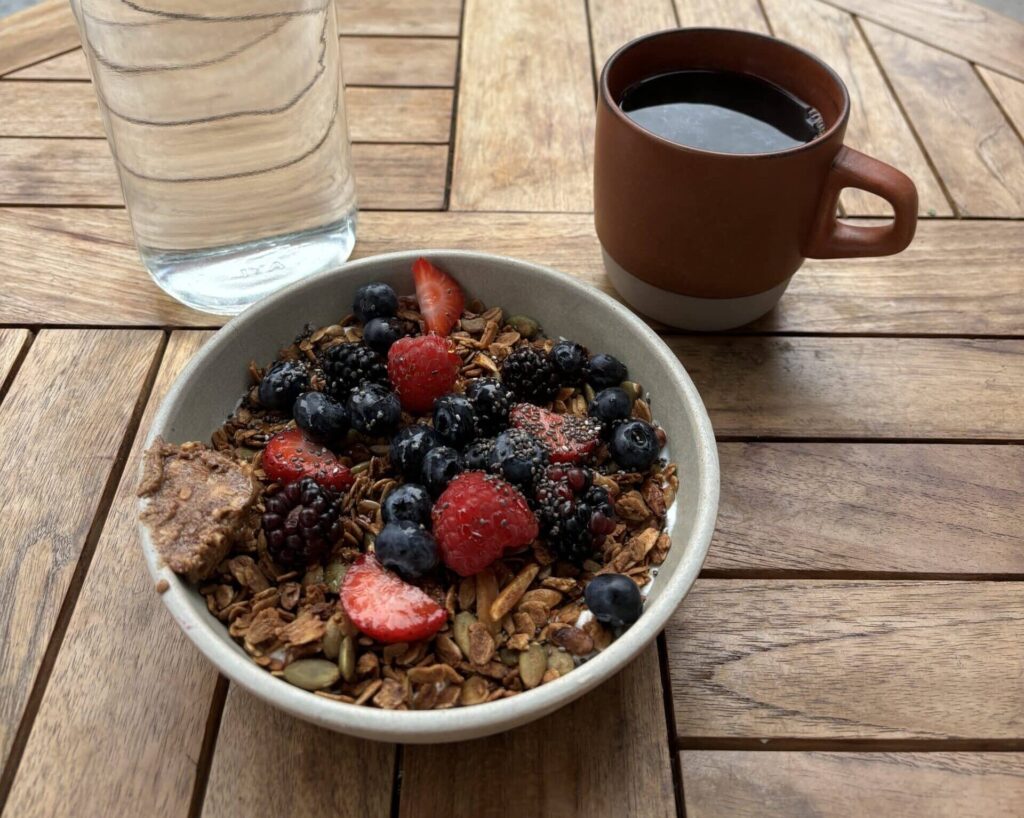 Yogurt and granola bowl with black coffee at St. Jardim, New York.